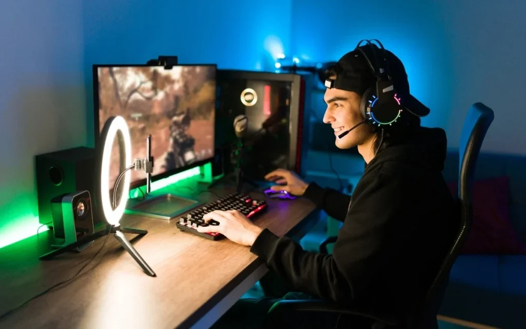 Gamer wearing headset streaming gameplay with RGB lighting and ring light
